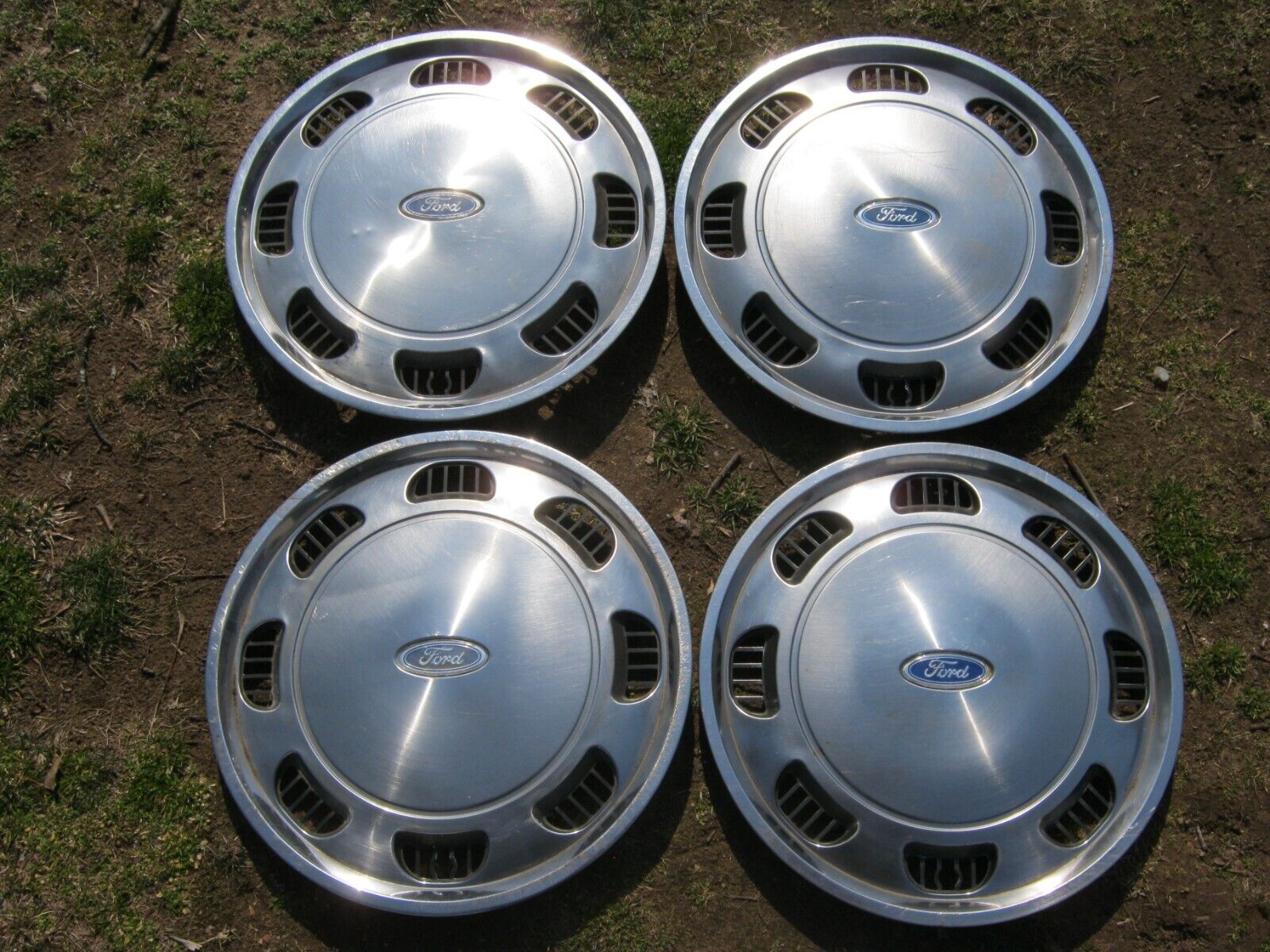 Factory original 1986 to 1990 Ford Tempo Aerostar 14 inch hubcaps wheel covers