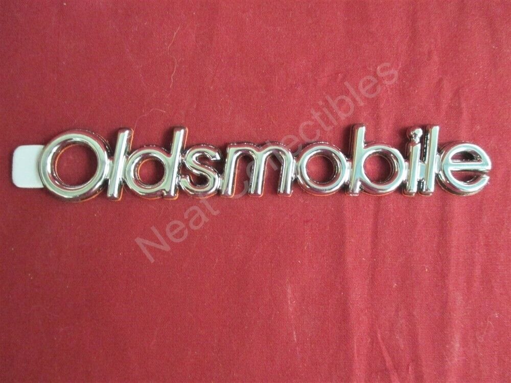 NOS Oldsmobile Cutlass Supreme Ciera Brougham Header Panel Nameplate Emblem
